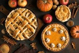 apple pie and pumpkin pie on table